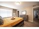 Bedroom with modern decor, wooden furniture, and natural light from the large window at 1511 Living Desert Dr # C, Las Vegas, NV 89119