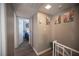 Hallway with wood floors, leading to a bedroom with blue bedding, enhanced with city art at 1511 Living Desert Dr # C, Las Vegas, NV 89119