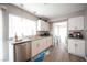 Bright kitchen featuring white cabinets, stainless steel appliances, and granite countertops at 1511 Living Desert Dr # C, Las Vegas, NV 89119