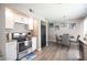 Bright kitchen featuring stainless steel appliances, white cabinetry, and modern fixtures at 1511 Living Desert Dr # C, Las Vegas, NV 89119