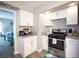 Well-equipped kitchen with white cabinets, granite countertops, and stainless steel gas range at 1511 Living Desert Dr # C, Las Vegas, NV 89119