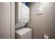 Convenient laundry area equipped with a stacked washer and dryer unit at 1511 Living Desert Dr # C, Las Vegas, NV 89119