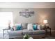 Comfortable living room with plush gray couch and contemporary decor at 1511 Living Desert Dr # C, Las Vegas, NV 89119