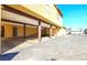 Open parking featuring brown support beams, tan siding and concrete paving at 1511 Living Desert Dr # C, Las Vegas, NV 89119