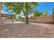 Spacious backyard with a covered patio, rock landscaping, and block wall, ideal for relaxation and privacy at 1733 Gentle Brook St, North Las Vegas, NV 89084