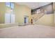 Spacious living room with high ceilings, natural light, and staircase access at 1733 Gentle Brook St, North Las Vegas, NV 89084