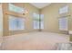 Open living room featuring high ceilings, multiple windows, and plush carpeting at 1733 Gentle Brook St, North Las Vegas, NV 89084