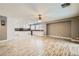 Open-concept living space with wood floors, ample lighting, and a seamless flow to the kitchen at 1733 Gentle Brook St, North Las Vegas, NV 89084