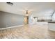 Spacious living area seamlessly connects to the kitchen with wood flooring at 1733 Gentle Brook St, North Las Vegas, NV 89084