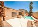 Outdoor oasis featuring a sparkling pool, built-in grill, spa, and lush palms for an entertainer's delight at 1742 Sand Storm Dr, Henderson, NV 89074
