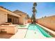 Private backyard with a refreshing pool, spa, outdoor kitchen and mature landscaping for entertaining and relaxation at 1742 Sand Storm Dr, Henderson, NV 89074