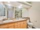 Bathroom featuring a large vanity with dual sinks, a big mirror, and a glass-enclosed shower at 1742 Sand Storm Dr, Henderson, NV 89074