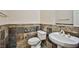 Stylish half-bathroom features a vessel sink and slate tile, adding a touch of modern design at 1742 Sand Storm Dr, Henderson, NV 89074