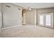 Spacious carpeted bedroom with high ceilings and double doors to the exterior at 1742 Sand Storm Dr, Henderson, NV 89074