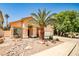 Inviting single-story home featuring well-maintained desert landscaping and a three-car garage at 1742 Sand Storm Dr, Henderson, NV 89074