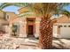 Welcoming single-story home with a well-manicured desert landscape and inviting entryway at 1742 Sand Storm Dr, Henderson, NV 89074
