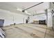 Spacious garage with ample lighting, storage cabinets, room for workbench, and door to the backyard at 1742 Sand Storm Dr, Henderson, NV 89074