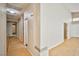 Long hallway with light wood flooring and white walls, connecting the home's different spaces at 1742 Sand Storm Dr, Henderson, NV 89074
