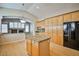 Bright kitchen features an island, granite countertops, and wood cabinets offering ample storage space at 1742 Sand Storm Dr, Henderson, NV 89074