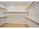 Walk-in closet with built-in shelving and wooden rods at 1742 Sand Storm Dr, Henderson, NV 89074
