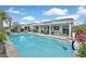 A captivating view of the backyard pool, complete with a slide, and covered patio perfect for outdoor enjoyment at 2011 Mountain Sunset Ave, North Las Vegas, NV 89031