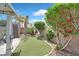 Backyard oasis with putting green, palm trees and flowering trees at 2011 Mountain Sunset Ave, North Las Vegas, NV 89031