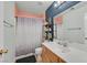 Colorful bathroom showcasing a shower/tub combo and vanity with storage at 2011 Mountain Sunset Ave, North Las Vegas, NV 89031