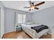 Relaxing bedroom featuring laminate floors, cool blue walls and a ceiling fan at 2011 Mountain Sunset Ave, North Las Vegas, NV 89031
