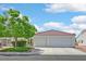 Charming home featuring a red tile roof, two-car garage, well-maintained lawn and mature landscaping at 2011 Mountain Sunset Ave, North Las Vegas, NV 89031