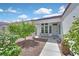 Inviting front entrance with a cozy seating area and lush landscaping, offering a warm welcome at 2011 Mountain Sunset Ave, North Las Vegas, NV 89031