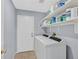 Laundry room with tile floors, shelving, and washer/dryer at 2011 Mountain Sunset Ave, North Las Vegas, NV 89031