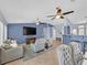 Bright living area with blue accent wall, tile floors, dining space, and a bar counter leading to the kitchen at 2011 Mountain Sunset Ave, North Las Vegas, NV 89031