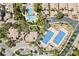 Aerial view showcases a community with a swimming pool, tennis courts, and palm trees at 2050 W Warm Springs Rd # 2822, Henderson, NV 89014