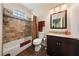 Well-lit bathroom with tile accents, a bathtub, and vanity with granite countertop at 2050 W Warm Springs Rd # 2822, Henderson, NV 89014