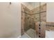 Modern bathroom with a glass-enclosed shower and tiled walls with decorative accents at 2050 W Warm Springs Rd # 2822, Henderson, NV 89014