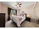 Comfortable bedroom with plush carpet, ceiling fan, and natural light from the window at 2050 W Warm Springs Rd # 2822, Henderson, NV 89014