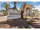 View of the Resort Villas Clubhouse sign with an inviting entryway surrounded by greenery at 2050 W Warm Springs Rd # 2822, Henderson, NV 89014