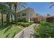 Beautiful home with lush landscaping, mature palm trees, and a charming stone pathway at 2050 W Warm Springs Rd # 2822, Henderson, NV 89014
