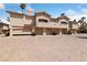 Exterior view of condos with garages and well-maintained landscaping in a community at 2050 W Warm Springs Rd # 2822, Henderson, NV 89014