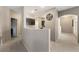 Hallway with a large wall clock, carpeted floors, and connecting access to the kitchen at 2050 W Warm Springs Rd # 2822, Henderson, NV 89014