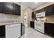 Functional kitchen featuring stainless steel appliances, granite countertops, and dark wood cabinets at 2050 W Warm Springs Rd # 2822, Henderson, NV 89014
