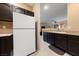 Spacious kitchen with dark cabinetry, granite countertops, white appliances, and an open layout at 2050 W Warm Springs Rd # 2822, Henderson, NV 89014