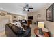 Inviting living room with a fireplace, modern ceiling fan, and comfortable leather seating arrangement at 2050 W Warm Springs Rd # 2822, Henderson, NV 89014