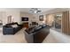 Cozy living room featuring a fireplace, outdoor patio entrance, and plush black leather sofas at 2050 W Warm Springs Rd # 2822, Henderson, NV 89014