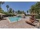 Resort-style pool area features clear blue water, stylish lounge chairs, and tropical landscaping at 2050 W Warm Springs Rd # 2822, Henderson, NV 89014