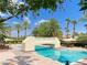 View of pool and bridge, surrounded by seating and palm trees, creating a serene outdoor space at 2050 W Warm Springs Rd # 2822, Henderson, NV 89014