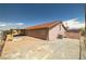 Exterior shot of home's backyard featuring gravel landscaping, a covered patio, and perimeter fencing at 2090 S Ambush St, Pahrump, NV 89048