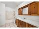 Bathroom with shower and tub combo, tile countertop, and wooden drawers at 2090 S Ambush St, Pahrump, NV 89048