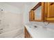 Bright bathroom featuring a tub and shower combo and wooden cabinets and drawers at 2090 S Ambush St, Pahrump, NV 89048