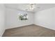 Large bedroom featuring neutral carpet, a ceiling fan, and a bright window at 2090 S Ambush St, Pahrump, NV 89048